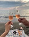 Couple clinking glasses of champagne on seashore