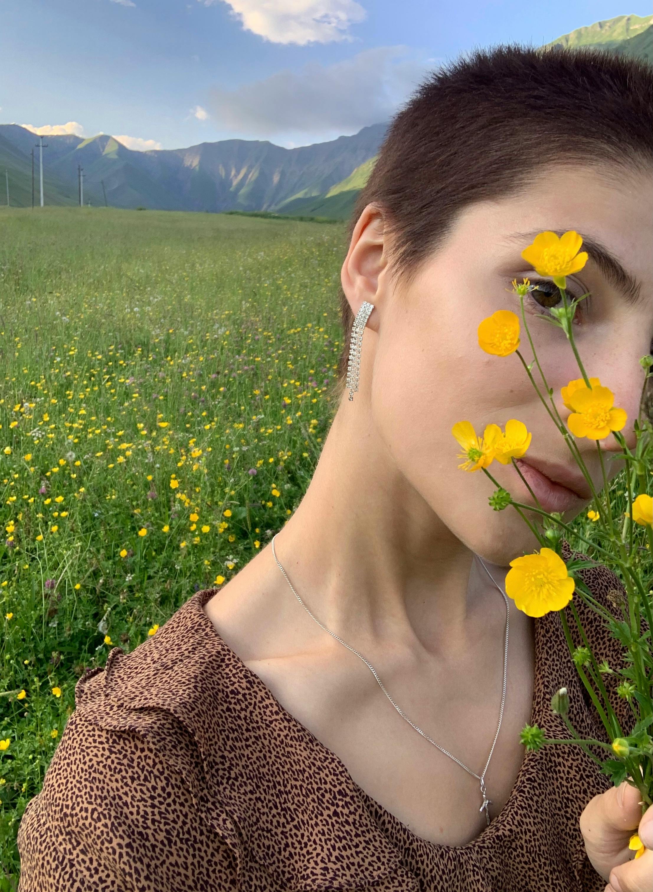 Young woman covering face with blooming flowers · Free Stock Photo