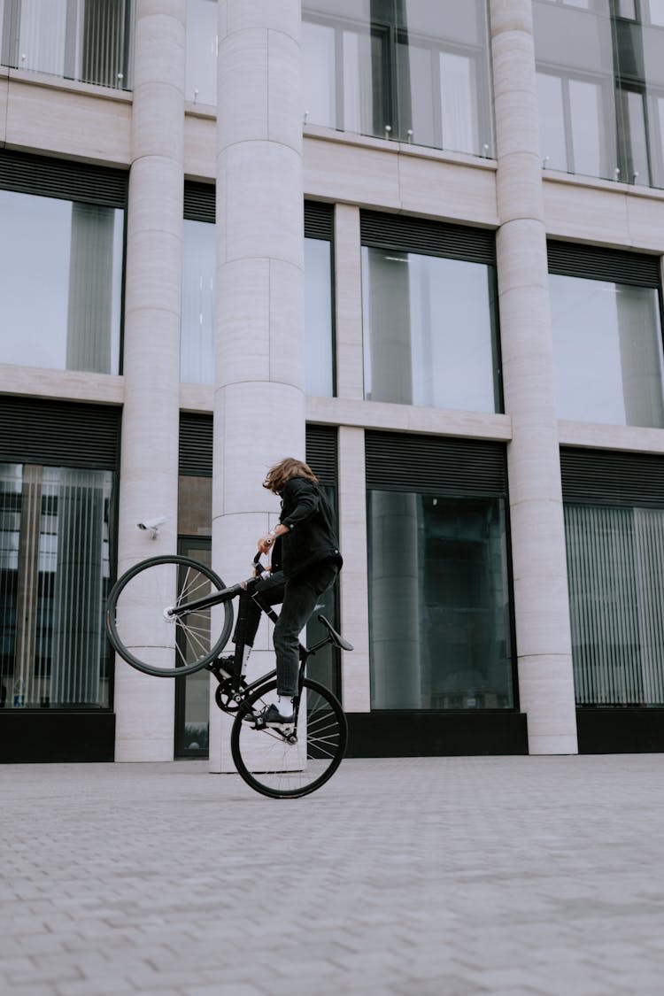 A Person Riding Bicycle Doing Wheelie