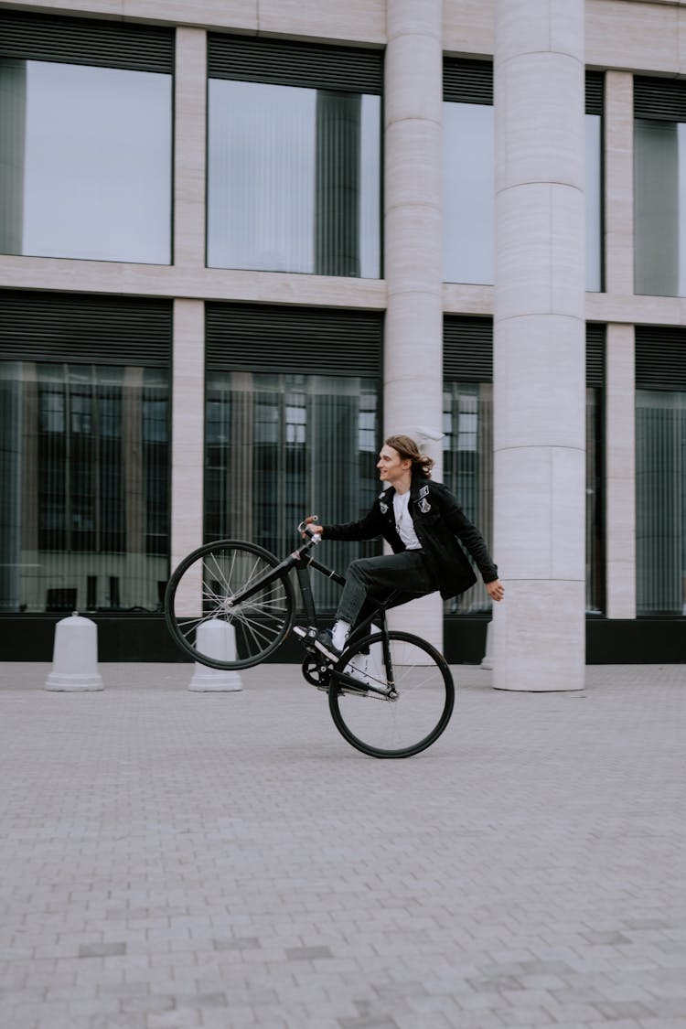 A Man Riding Bicycle Doing Wheelie