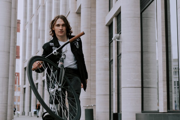 A Man Riding Fixie Bicycle Doing Wheelie