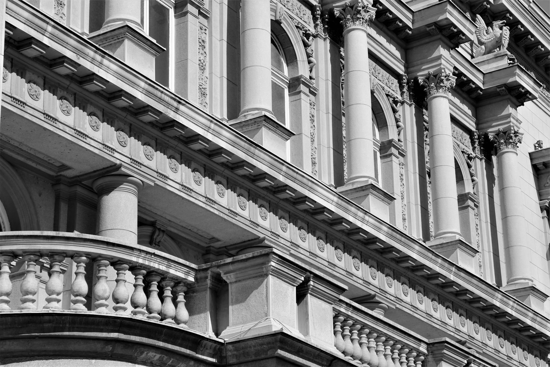 Neoclassical building facade with columns in Belgrade, Serbia captured in black and white.