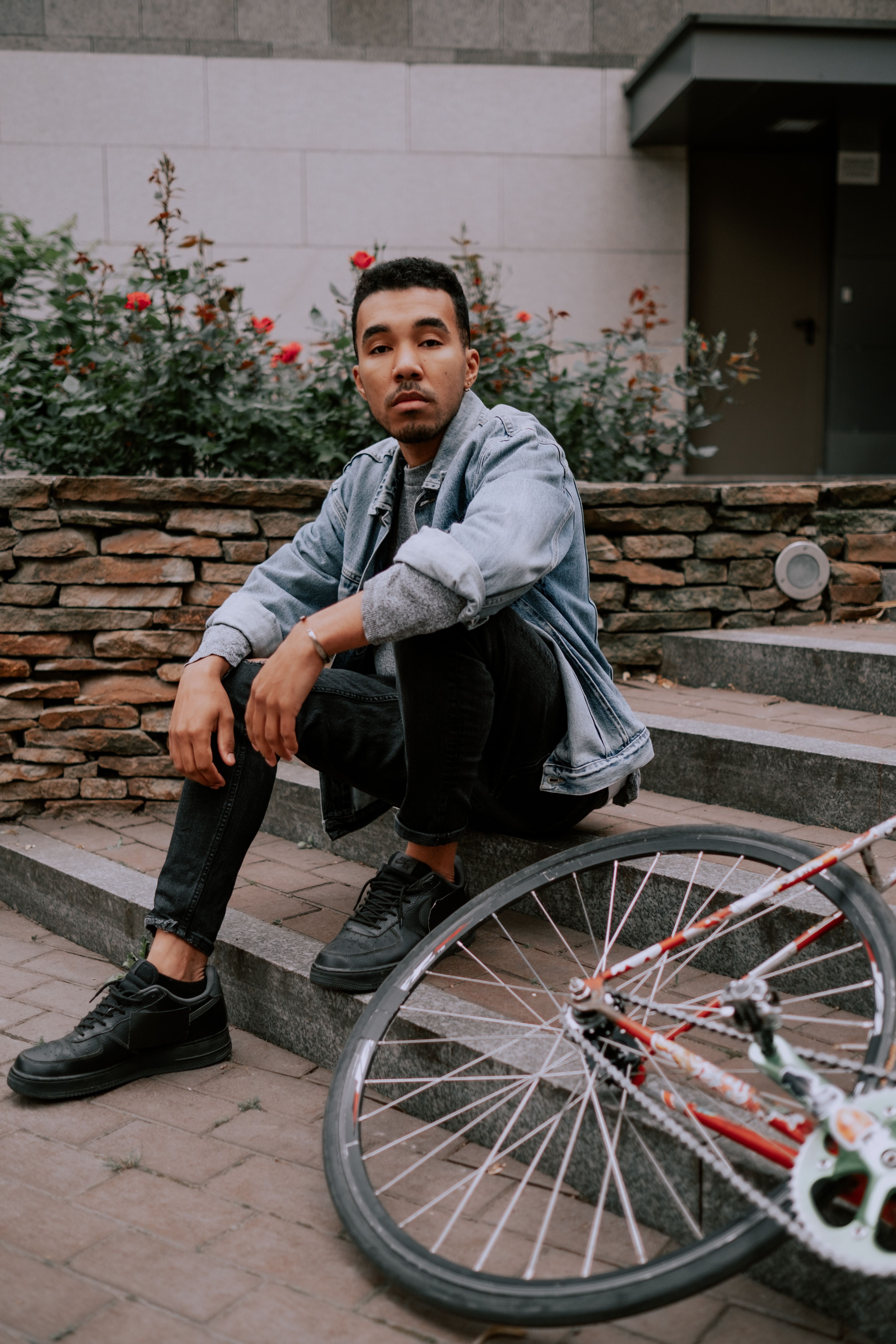 Man in Denim Jacket Sitting on Stairs on Street · Free Stock Photo