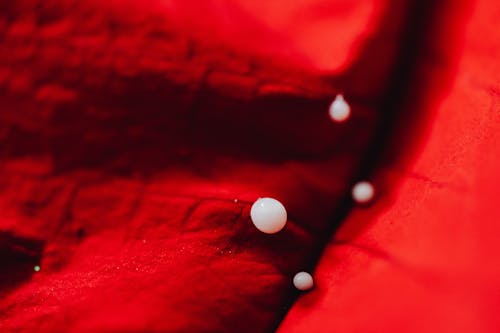 White Drops on Red Fabric