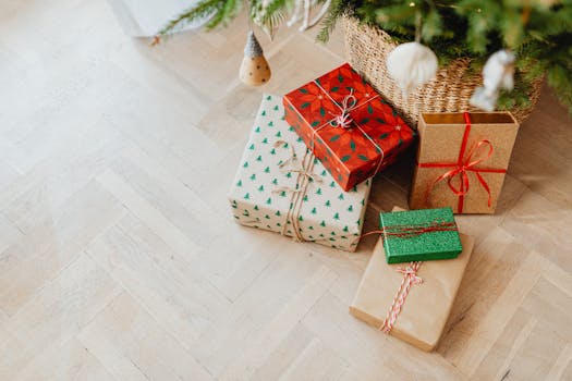 Close-up of beautifully wrapped presents under a fir tree, capturing the holiday spirit.