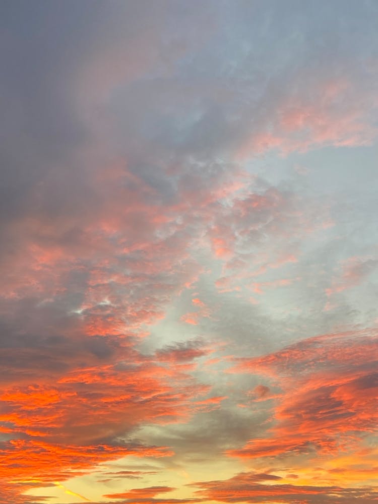 Clouds Over Sky Lightened By Rays Of Sun At Sunset