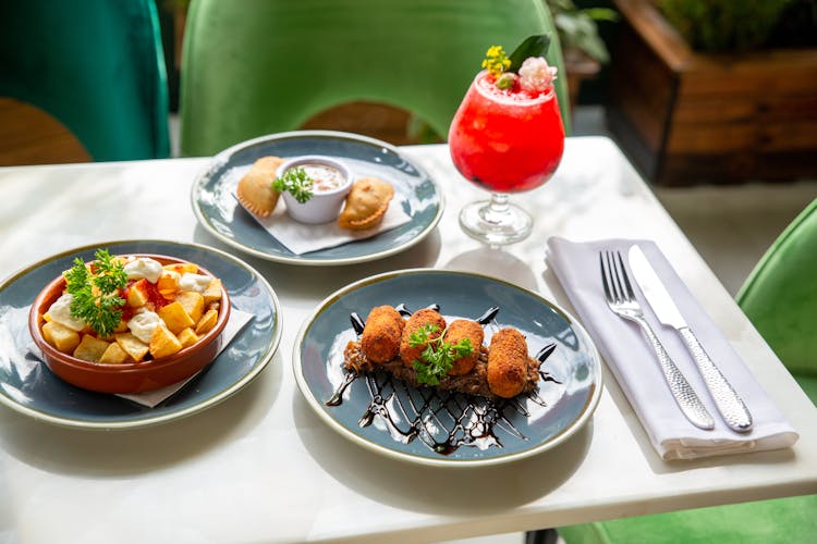 Variety Of Cooked Food On Ceramic Plates