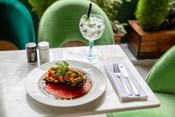 Delicious vegan dish paired with a refreshing cocktail, perfect for a summer lunch.