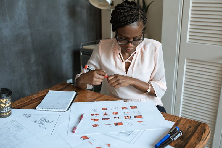 Woman Working In Pink Blouse Sitting And Holding Permanent Marker