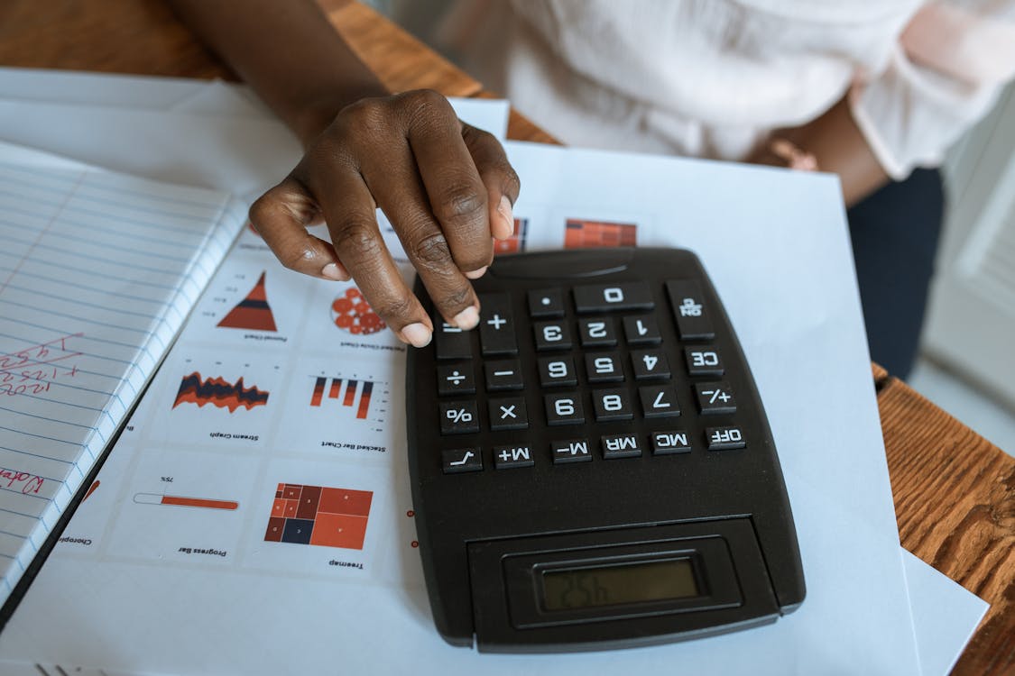 Free Person Using Black Desk Calculator Stock Photo