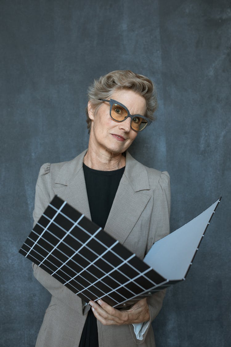 Woman In Beige Blazer Holding Hard Folder