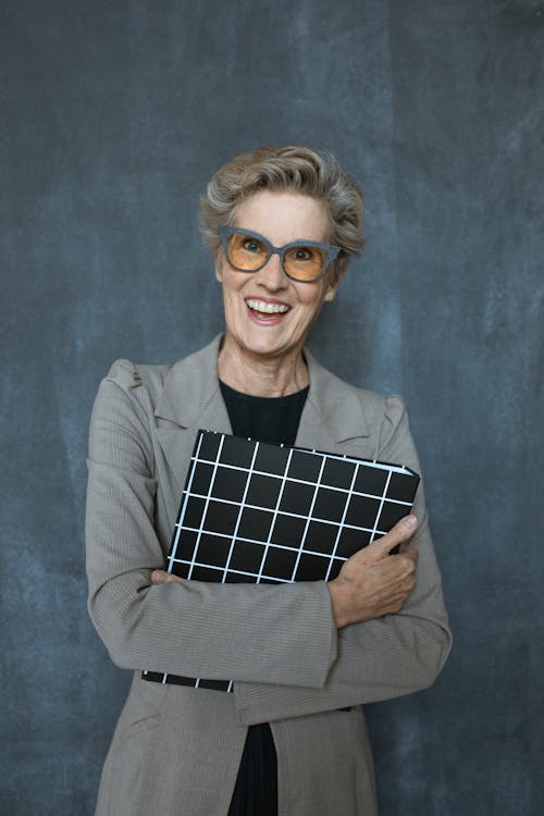 Elderly Woman in Black Shirt and Gray Blazer With Gray Framed Eyeglasses