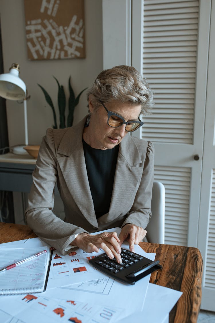 Woman In Beige Blazer Using Laptop Computer