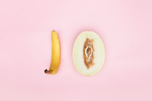 Sliced Melon and a Banana on Pink Surface