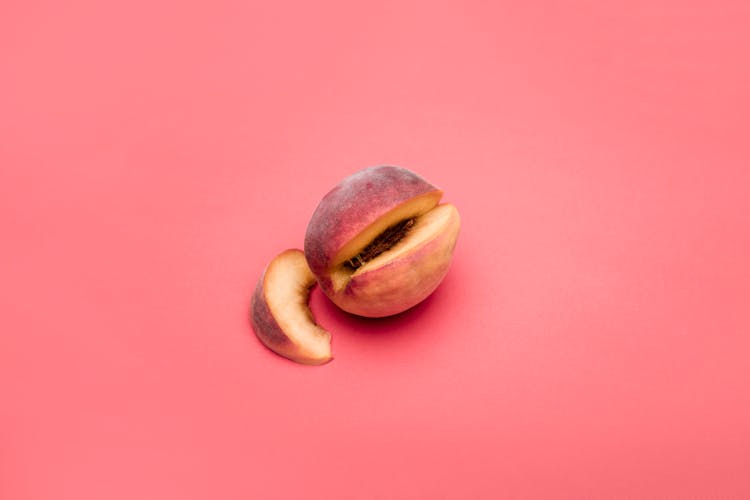 Cut Open Peach On Pink Background