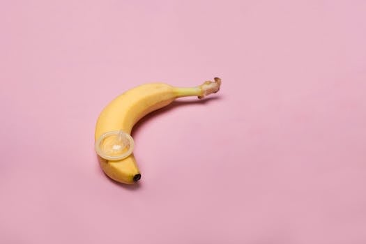 Studio shot of a banana with a condom, symbolizing safe sex and contraception awareness.