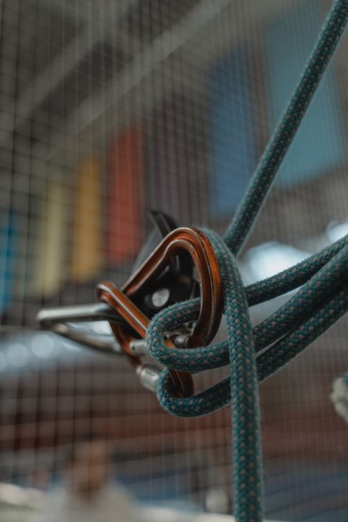 Free Detailed close-up of climbing gear featuring a rope and carabiners, highlighting the intricate knots. Stock Photo