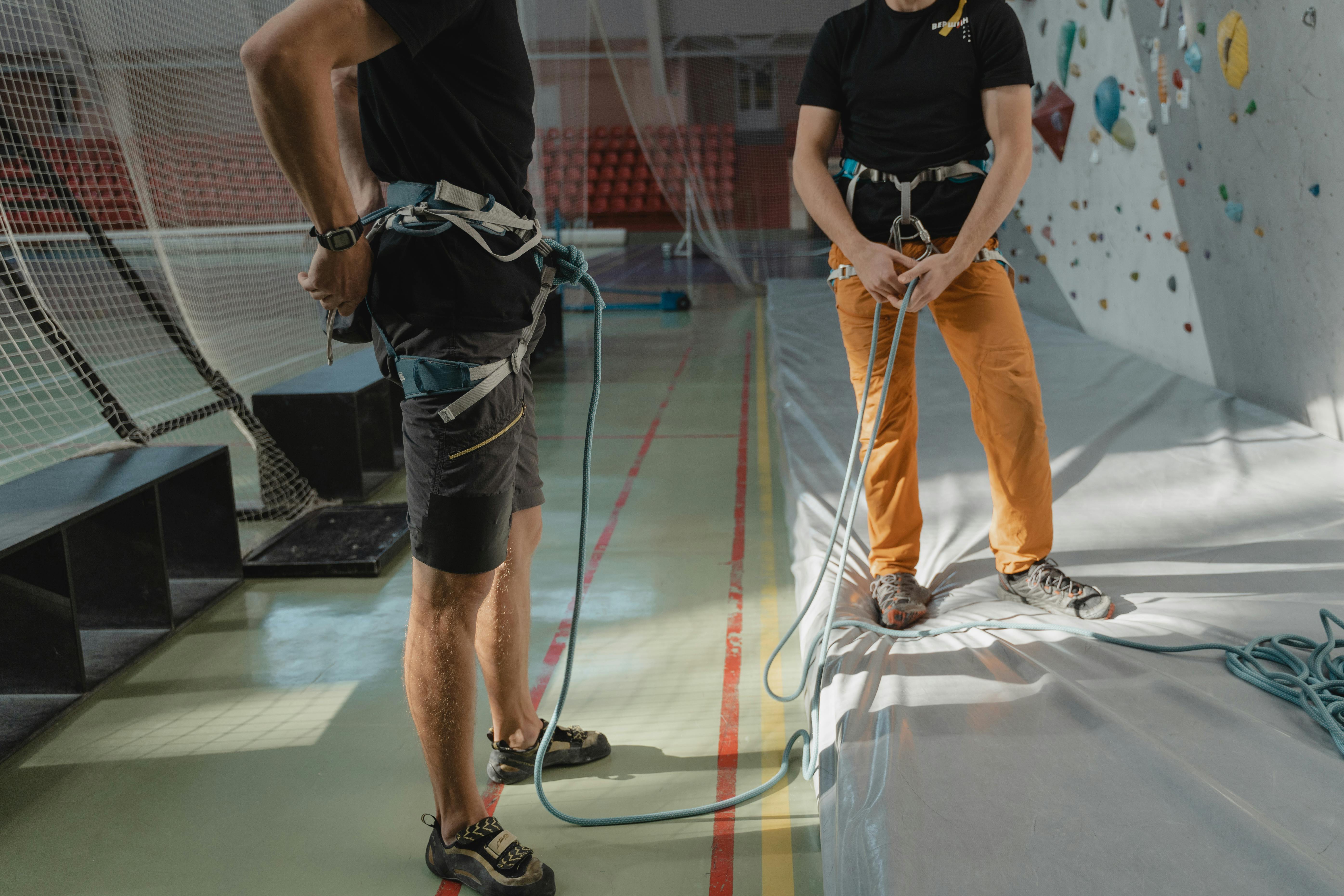 man in black t shirt and brown pants standing on white floor