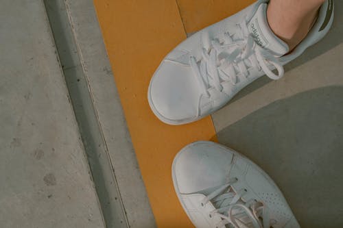 Free A Person Wearing White Adidas Sneakers  Stock Photo