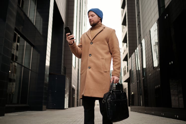 A Businessman Using Holding And Looking At His Smartphone 