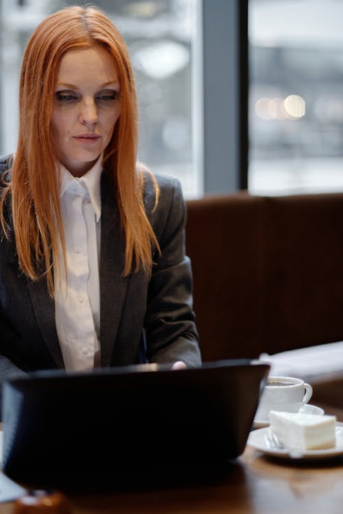 Woman in Gray Blazer Using a Laptop