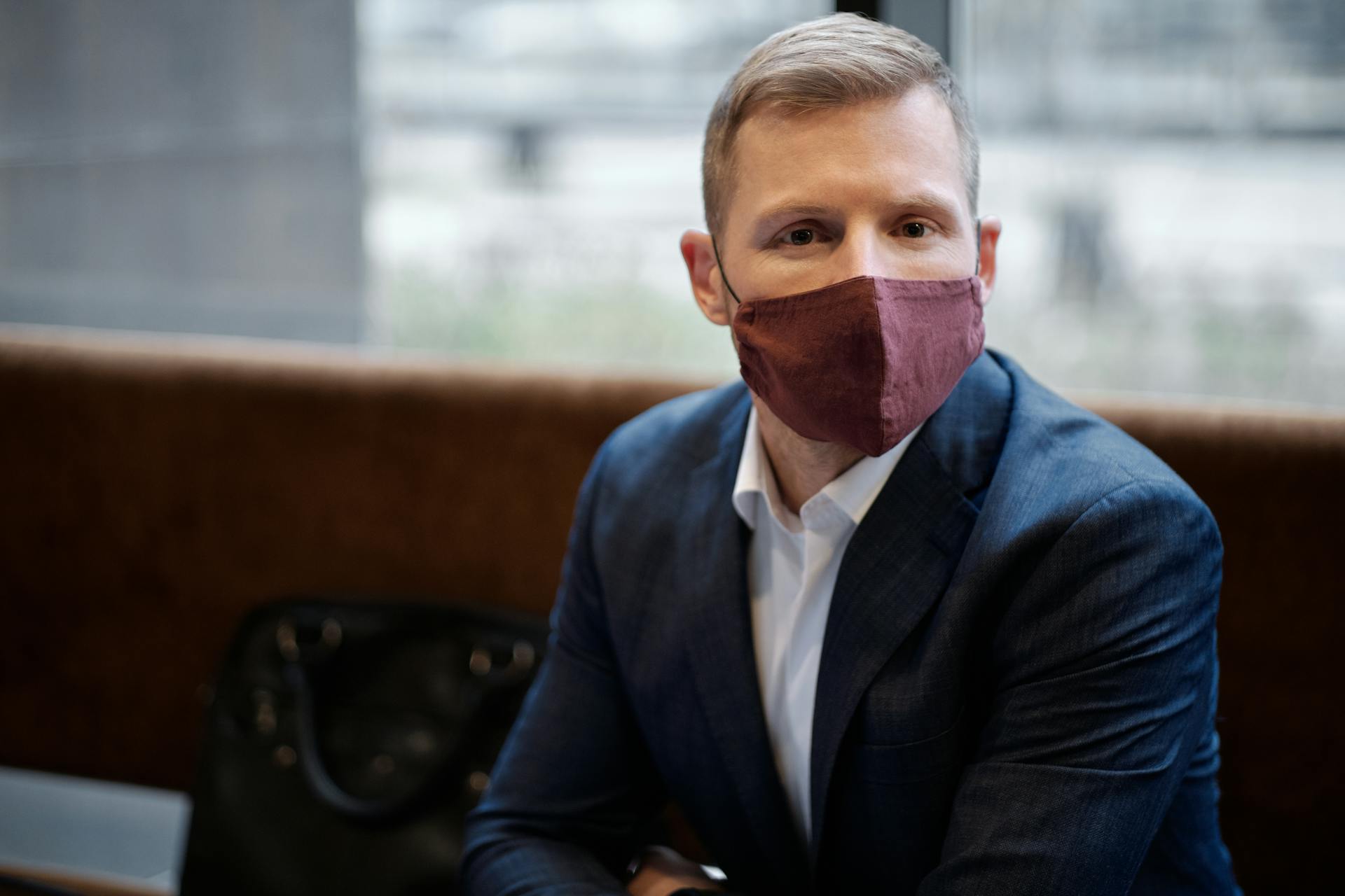 Portrait of a businessman wearing a mask, exemplifying adapting work environment in pandemic times.