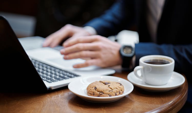 Close-up Of Cup Of Coffee And Cookie