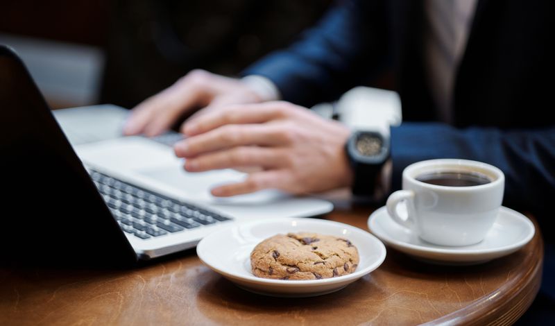 Professional working on laptop in a coffee shop setting