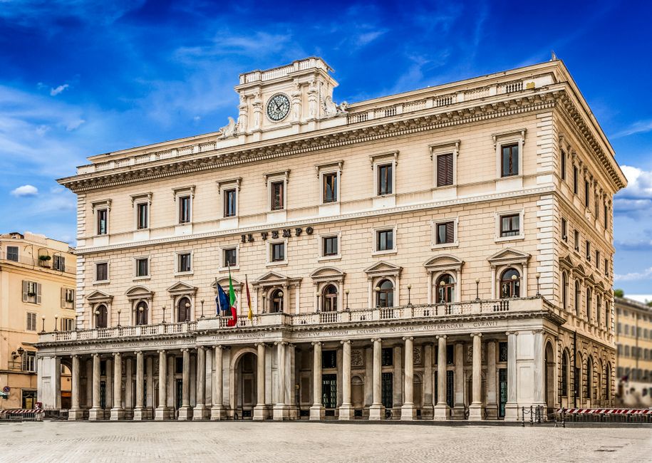 Elegant historical architecture in Piazza Colonna, Rome, with clear blue skies.