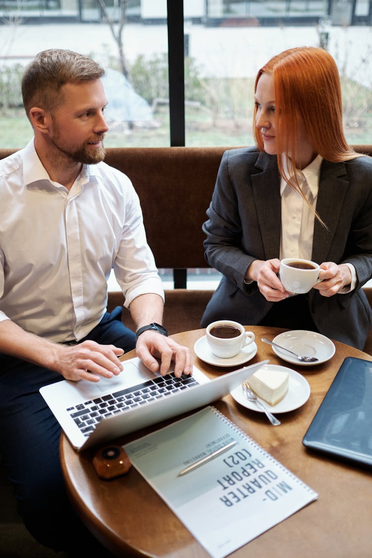 Man And Woman Having A Business Meeting In Coffee