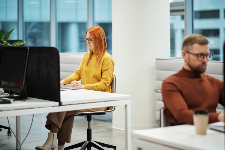 Woman In Yellow Sweater Working At The Office