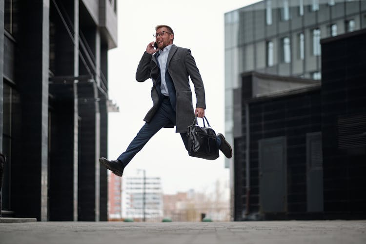 Talking On Phone Businessman Jumping