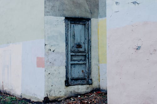 Old shabby door of weathered building