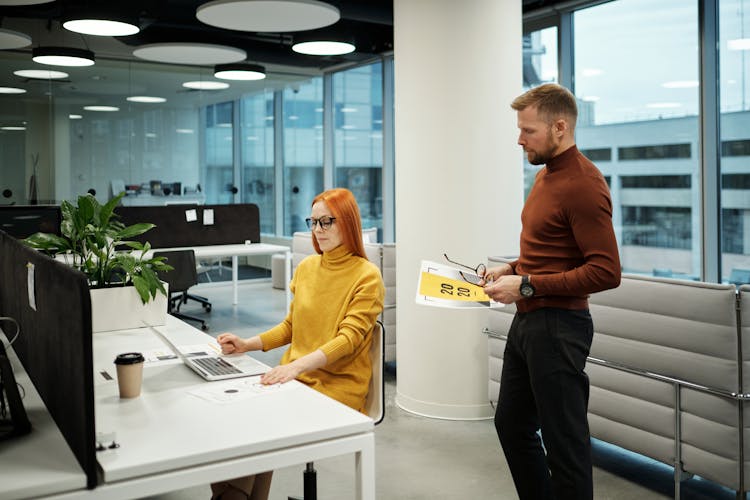 Man And Woman Working Together At The Office