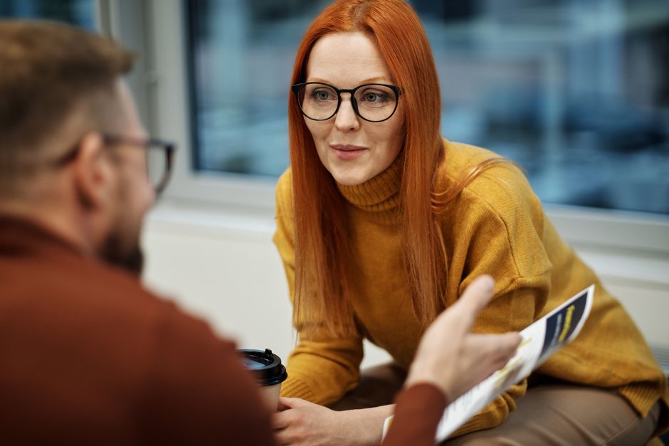 Business colleagues engaging in a productive discussion in an office setting.