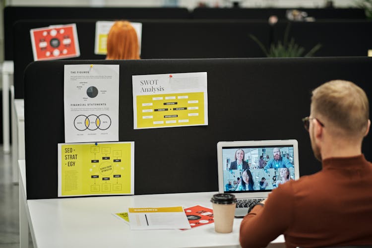 Man Sitting At Desk With Laptop In The Office