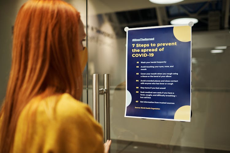 A Woman Reading A Poster