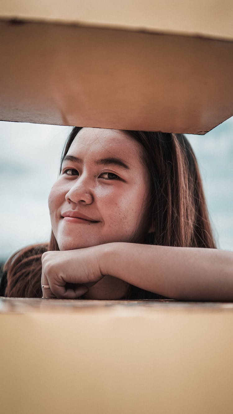 Portrait Of Woman Looking Through Gap In Stairs