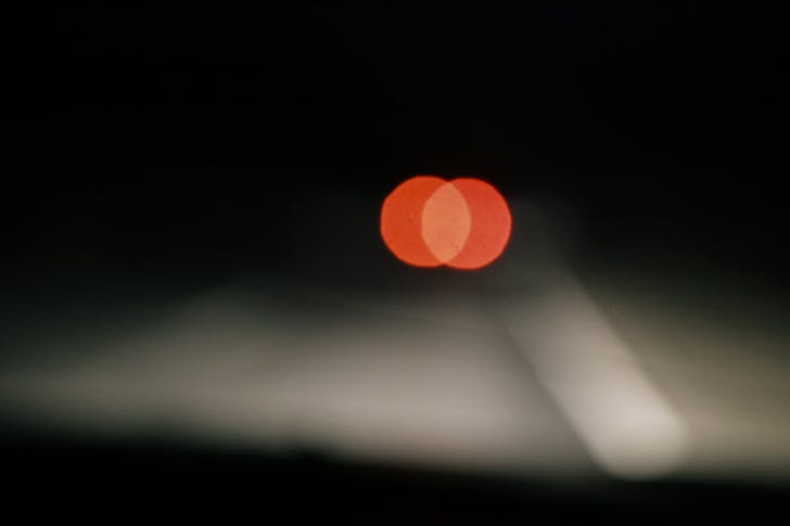 Stop light of automobile on road at night
