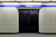 Gate under inscriptions against platform of metro station