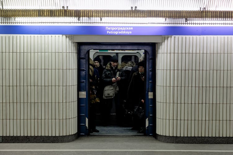 Passengers On Subway Train With Open Doors Against Platform