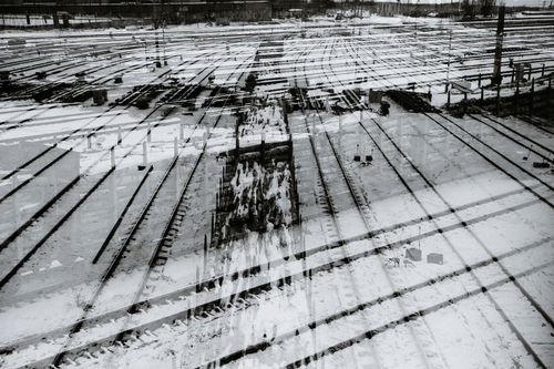 Free Black and white double exposure of long railroad station with metal rails located on street in city in winter time Stock Photo
