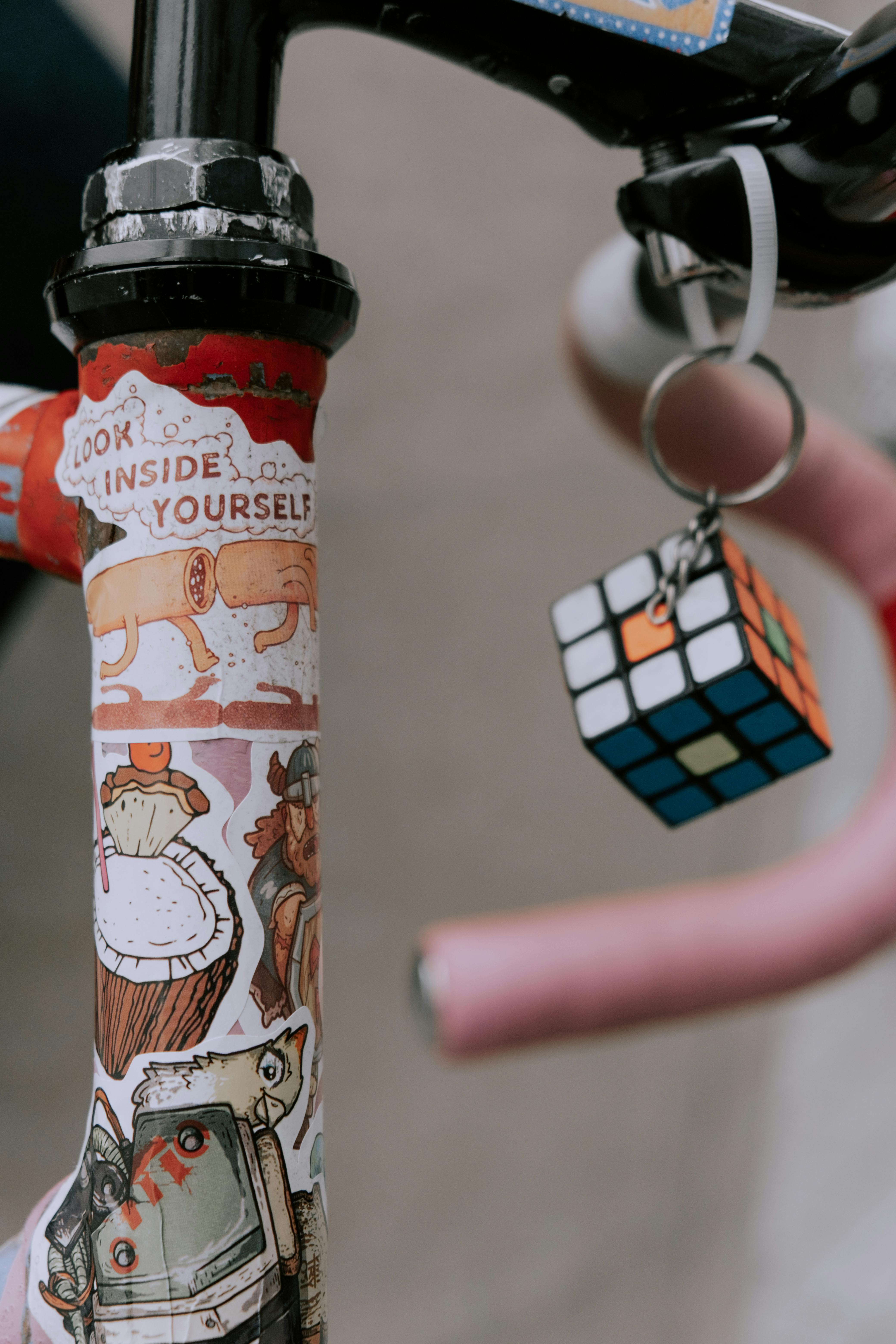 Rubiks Cube Keychain on the Bicycle Handlebar Free Stock Photo