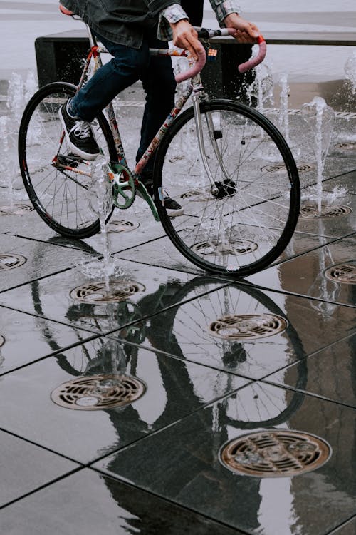 Man Riding Bike on Floor Fountain