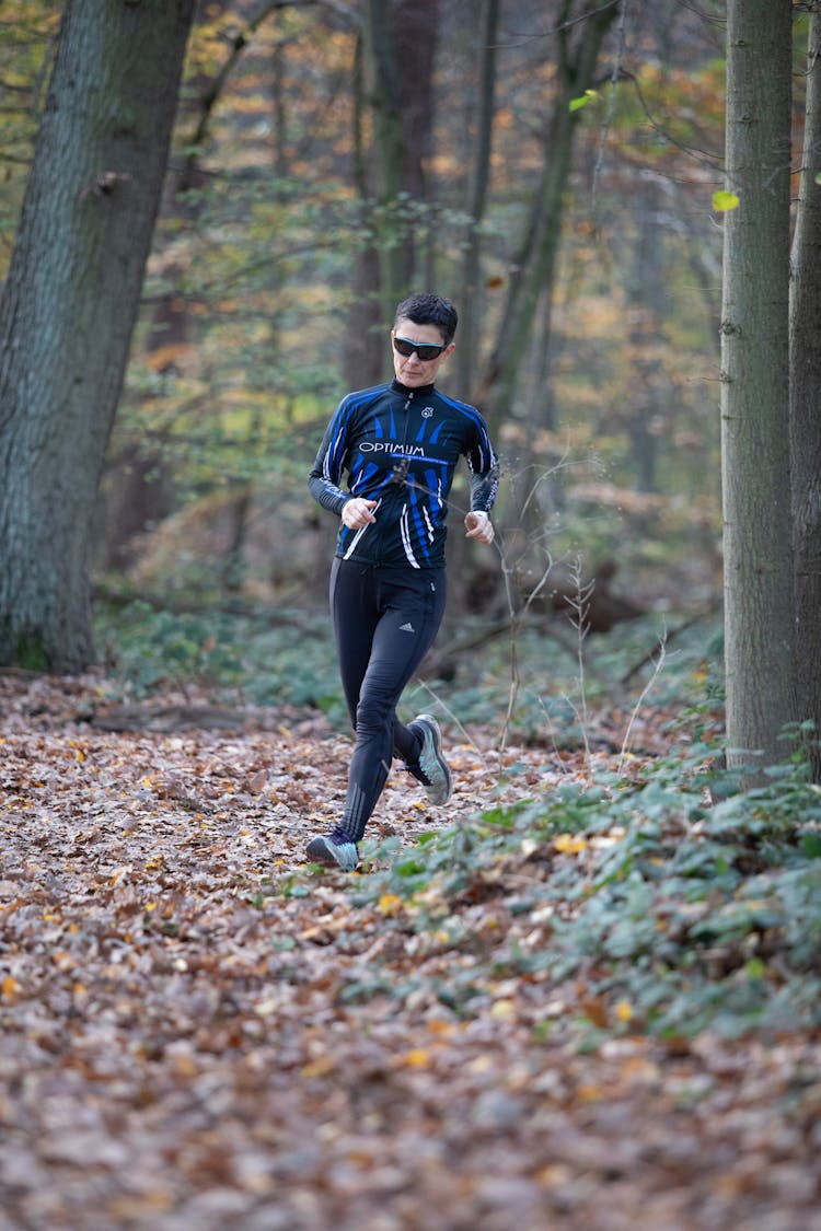 A Woman Running In The Forest