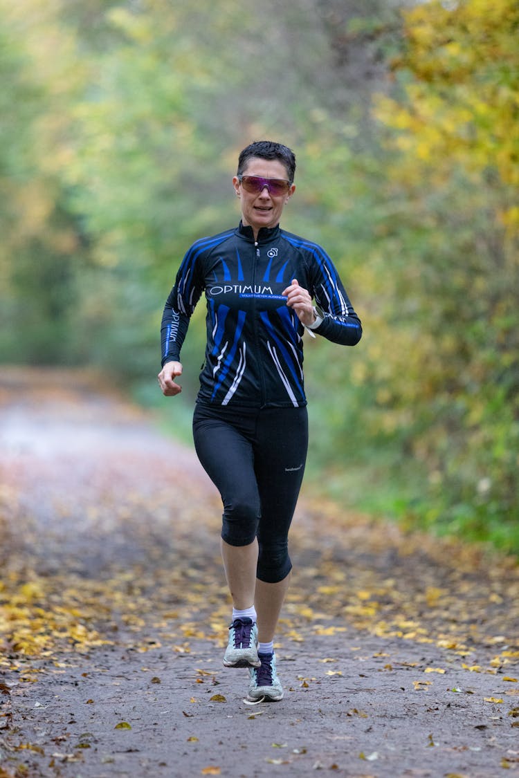 A Woman In Activewear Running 