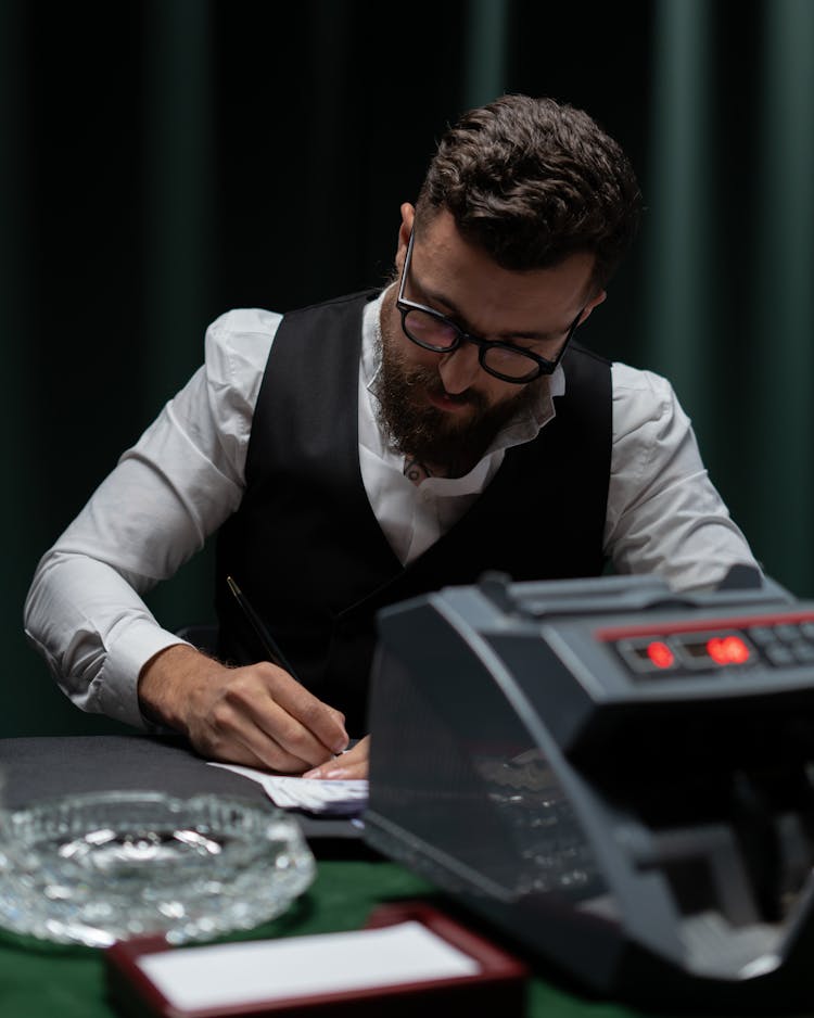 Croupier In Black Vest Counting 