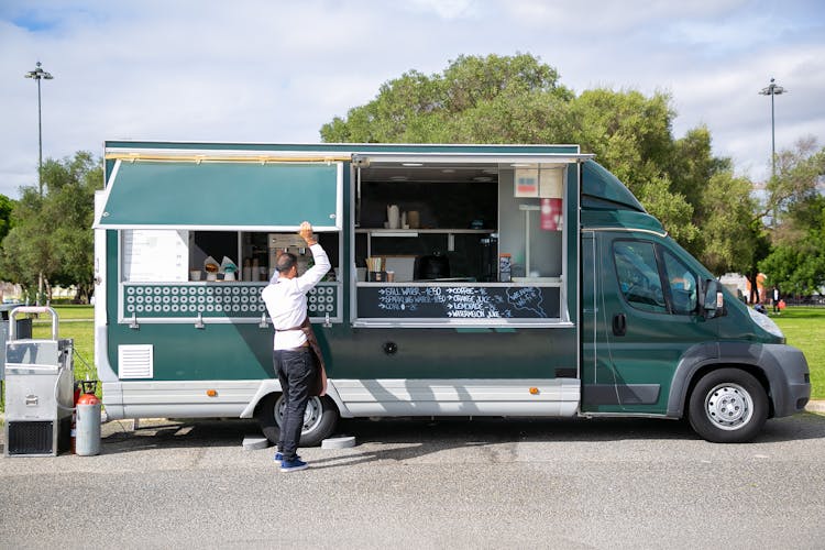 Male Seller Preparing Food Truck For Work