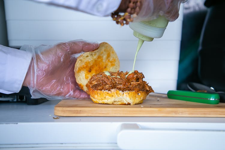 Chef Preparing Burger With Fried Pork And Sauce