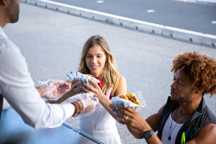 Seller Giving Order To Multiethnic Couple